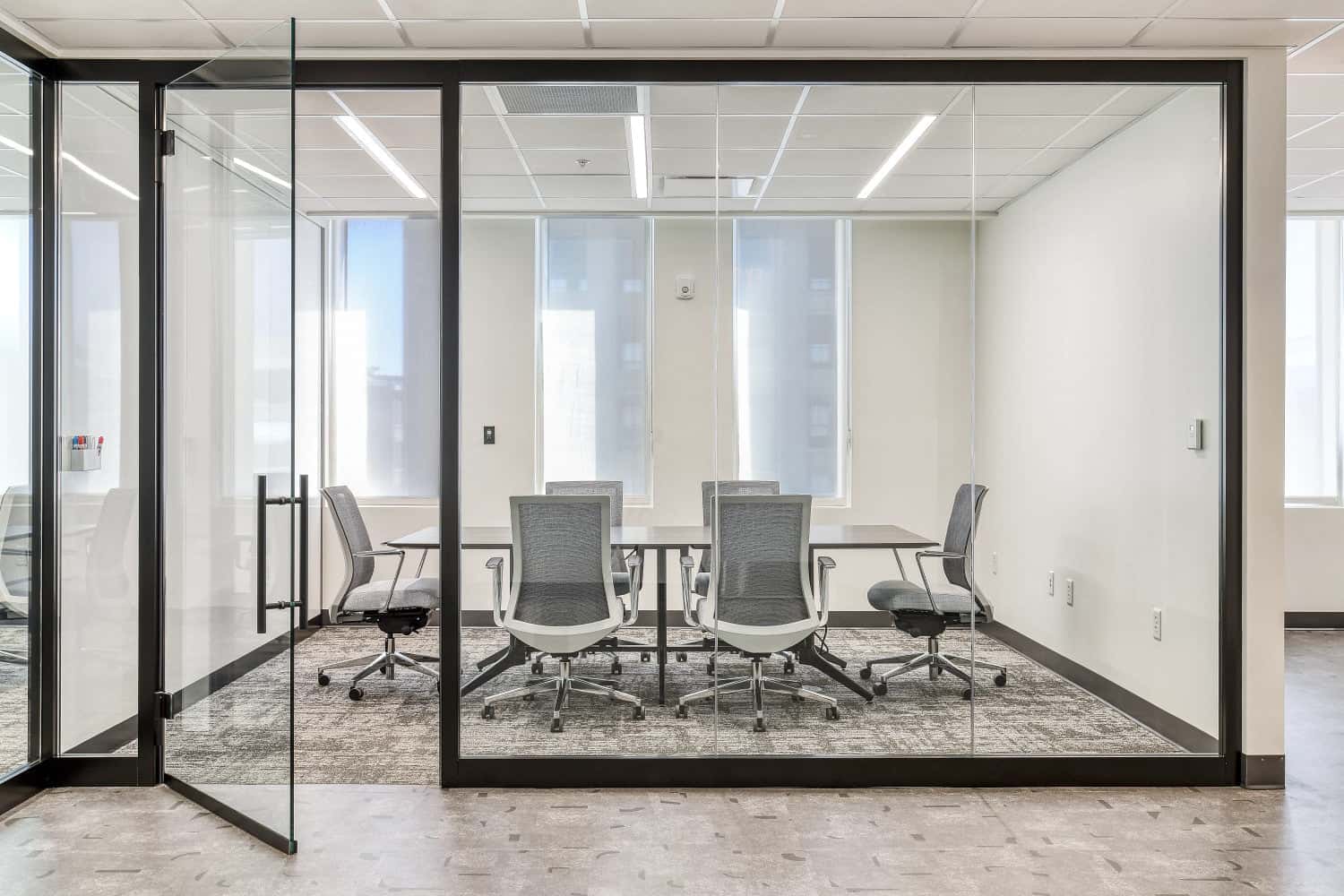 Corporate conference room with glass partition walls and modern task seating